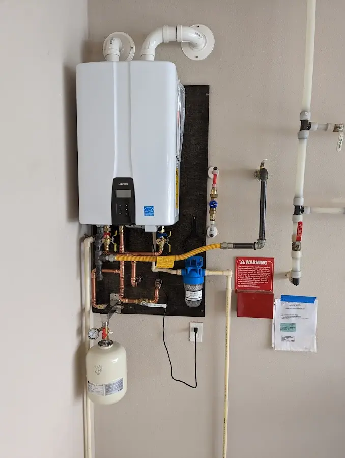 Professional plumber installing copper piping in a Tuscarora home